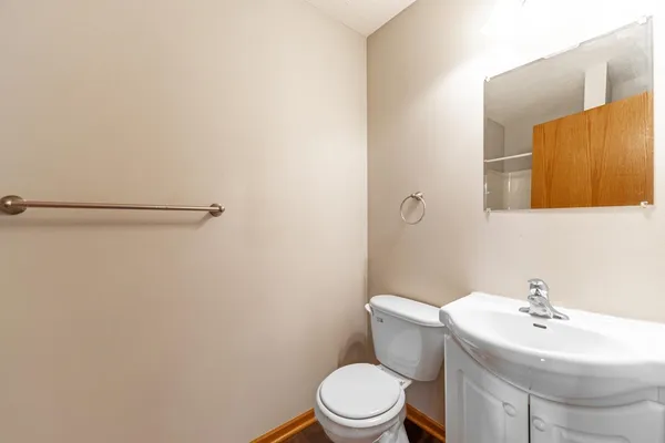 a white toilet sitting next to a bathroom sink