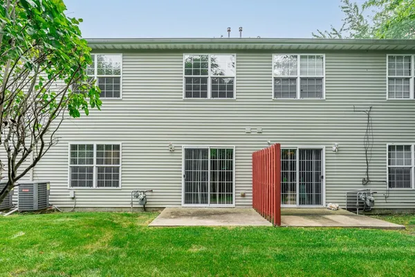a front view of a house with a yard and a garage