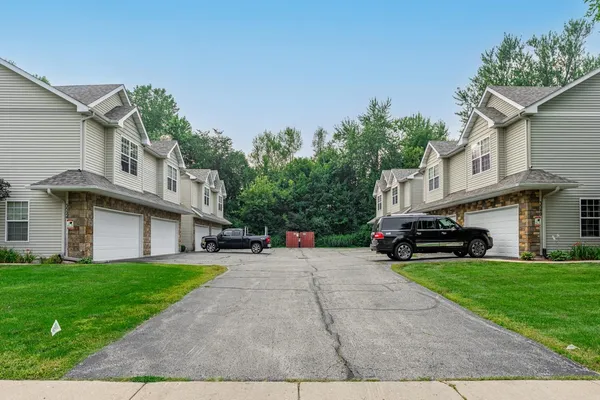 a view of a house with a yard and sitting area