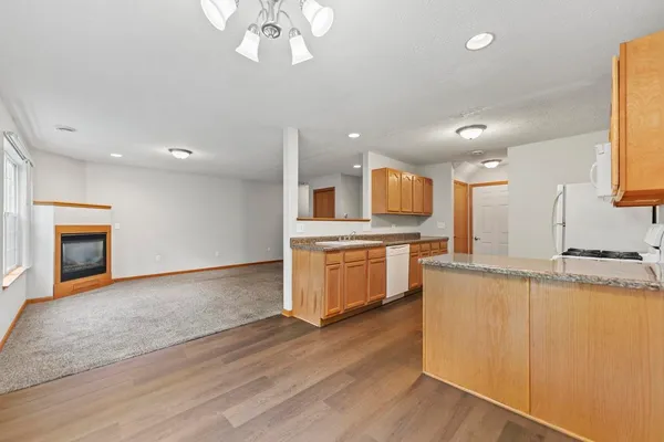 a large kitchen with stainless steel appliances granite countertop a stove and a sink