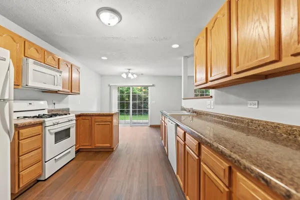 a kitchen with stainless steel appliances granite countertop a stove and a sink