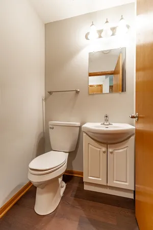 a bathroom with a sink toilet and mirror