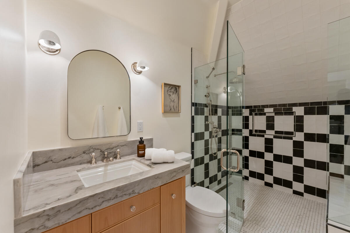 13100 Ojai Road Santa Paula, CA 93060 - Photo 36 of 60 a bathroom with a granite countertop sink a toilet and a mirror