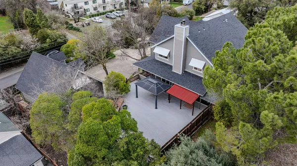 a backyard of a house with barbeque oven and outdoor seating
