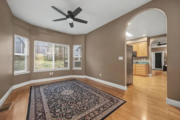 a kitchen with granite countertop cabinets stainless steel appliances and a wooden floor
