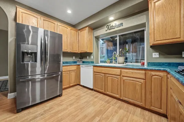a kitchen with stainless steel appliances granite countertop a refrigerator microwave and sink