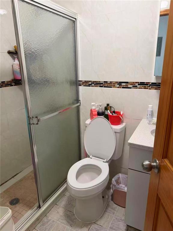5409 6th Avenue Brooklyn, NY 11220 - Photo 4 of 12 a white toilet sitting next to a bathroom sink