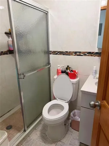a white toilet sitting next to a bathroom sink