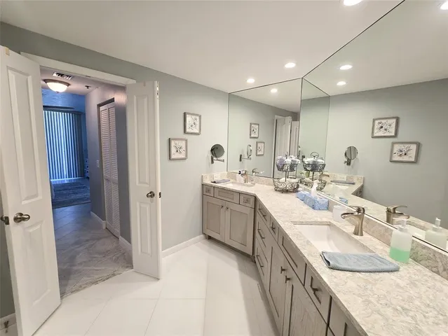 a bathroom with a granite countertop sink mirror and double