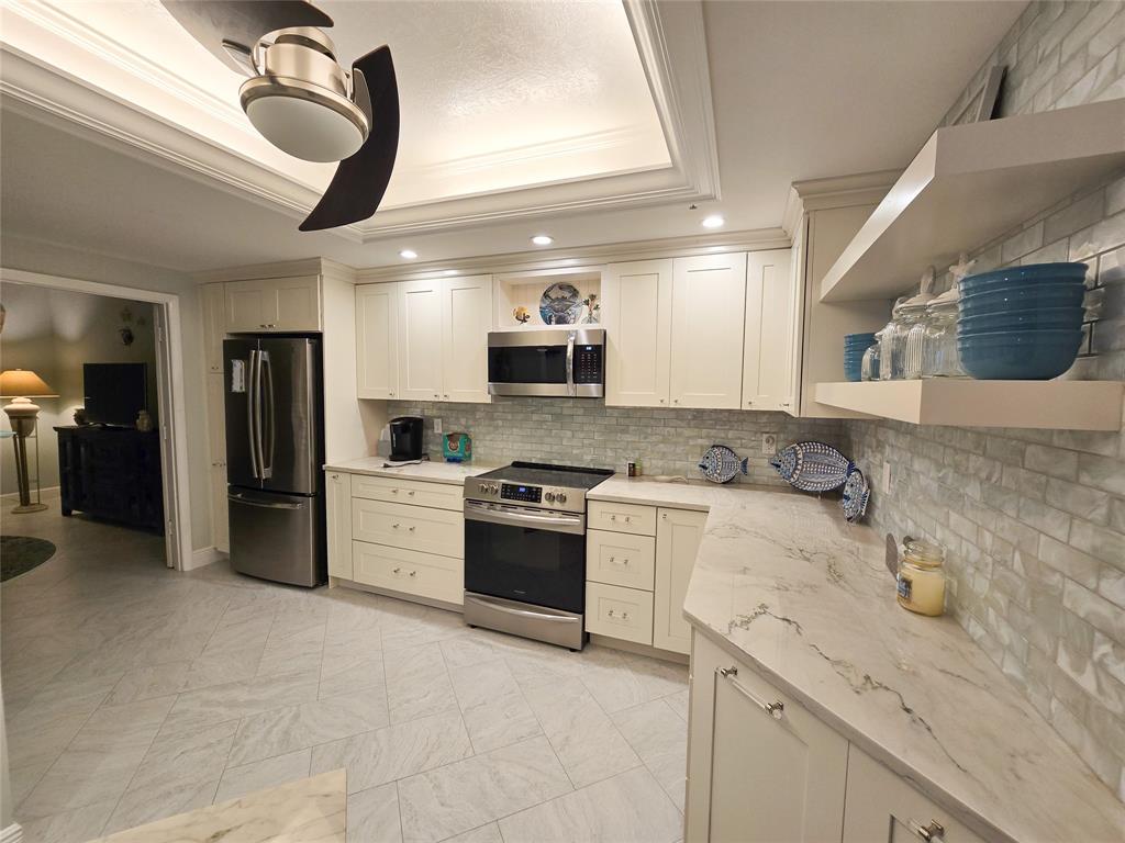 3120 North Hwy A1A, Unit 1302 Fort Pierce, FL 34949 - Photo 18 of 33 a kitchen with a sink stainless steel appliances and cabinets