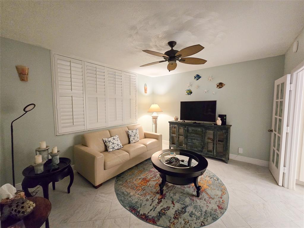 3120 North Hwy A1A, Unit 1302 Fort Pierce, FL 34949 - Photo 20 of 33 a living room with furniture a flat screen tv and a fireplace