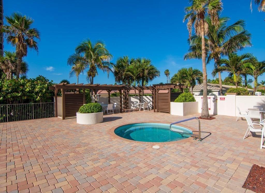 3120 North Hwy A1A, Unit 1302 Fort Pierce, FL 34949 - Photo 28 of 33 a swimming pool with yard and outdoor seating