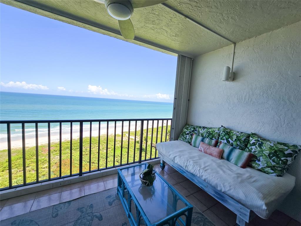 3120 North Hwy A1A, Unit 1302 Fort Pierce, FL 34949 - Photo 10 of 33 a balcony with furniture and wooden floor
