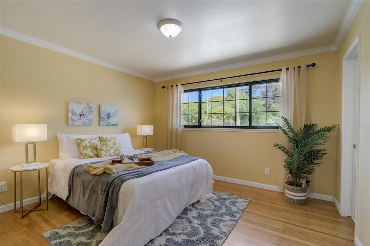 38061 Blacow Road Fremont, CA 94536 - Photo 42 of 65 a bedroom with a large bed and a potted plant