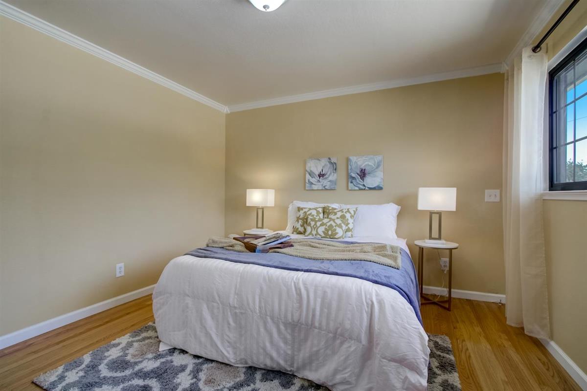 38061 Blacow Road Fremont, CA 94536 - Photo 45 of 65 a bedroom with a bed and a lamp