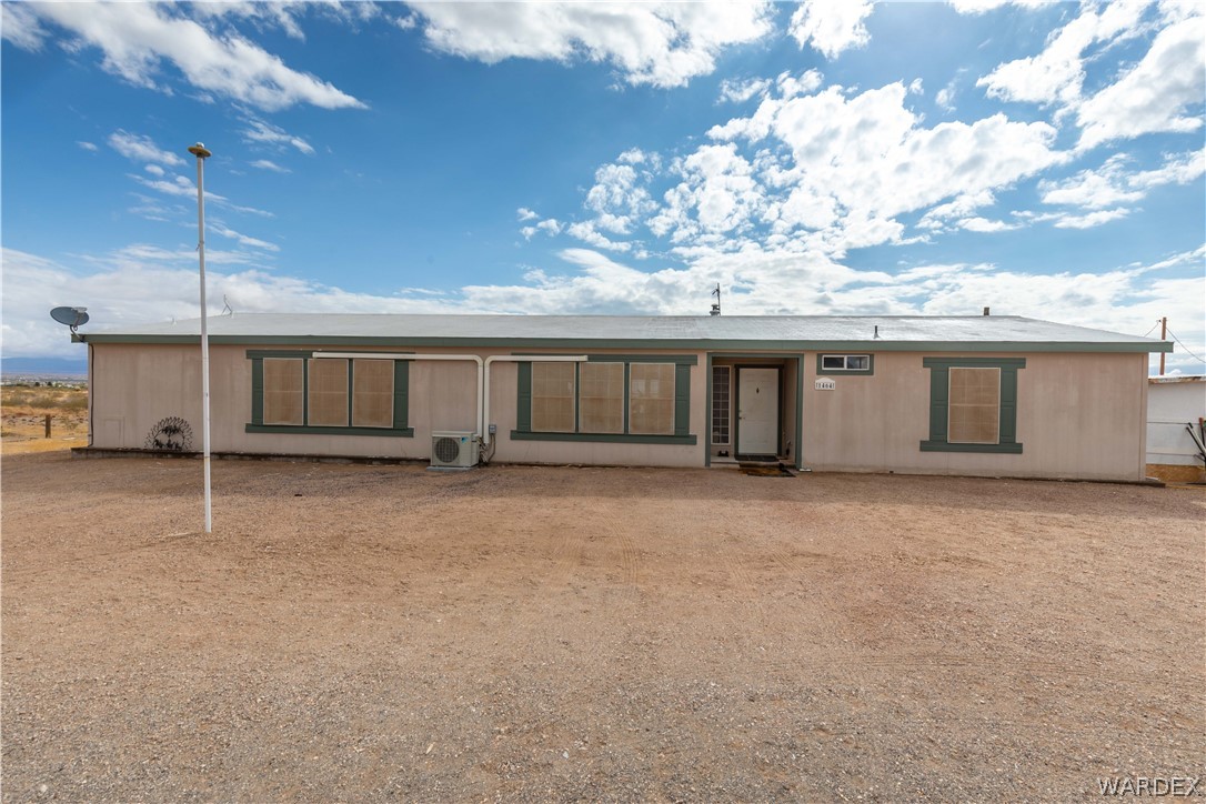 1464 South Dragoon Road Golden Valley, AZ 86413 - Photo 1 of 47 a view of a house with a garage and a yard