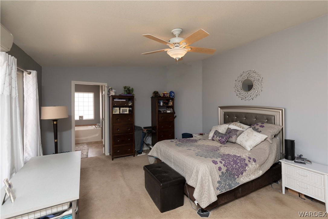 1464 South Dragoon Road Golden Valley, AZ 86413 - Photo 12 of 47 a bedroom with a bed and a chandelier
