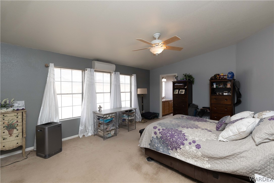 1464 South Dragoon Road Golden Valley, AZ 86413 - Photo 13 of 47 a bedroom with a bed and a large window