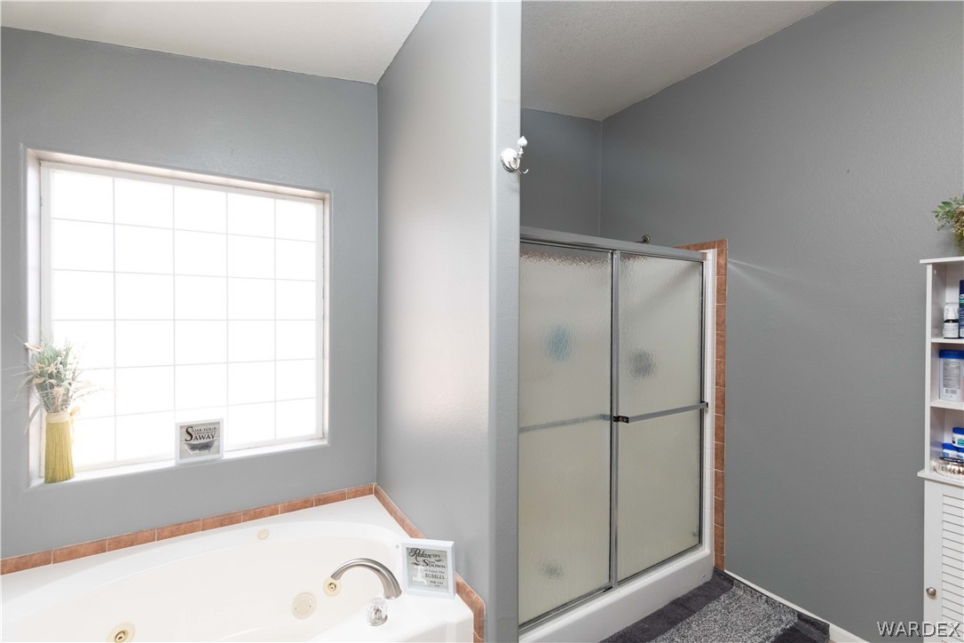 1464 South Dragoon Road Golden Valley, AZ 86413 - Photo 16 of 47 a bathroom with a bathtub and a window