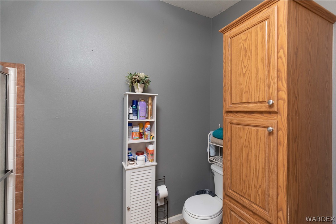 1464 South Dragoon Road Golden Valley, AZ 86413 - Photo 17 of 47 a white toilet sitting next to a bathroom sink