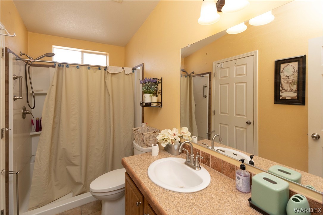 1464 South Dragoon Road Golden Valley, AZ 86413 - Photo 20 of 47 a bathroom with a sink toilet and shower