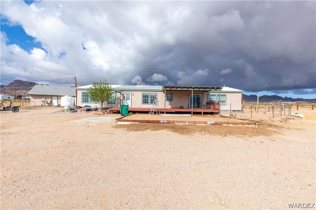 1464 South Dragoon Road Golden Valley, AZ 86413 - Photo 31 of 47 a view of house with yard and car parked