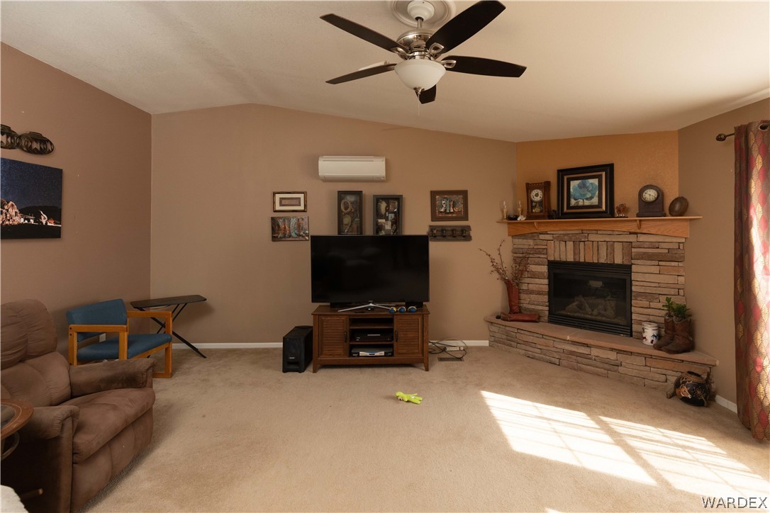 1464 South Dragoon Road Golden Valley, AZ 86413 - Photo 4 of 47 a living room with furniture a flat screen tv and a fireplace