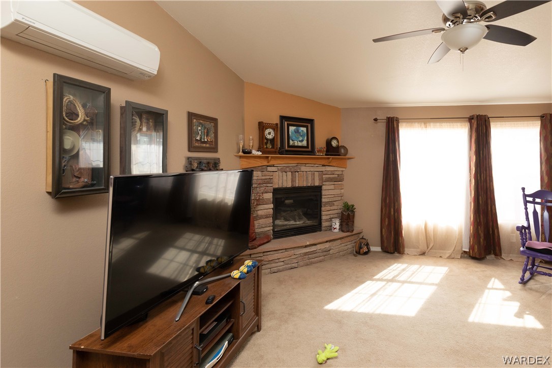 1464 South Dragoon Road Golden Valley, AZ 86413 - Photo 5 of 47 a living room with furniture and a fireplace