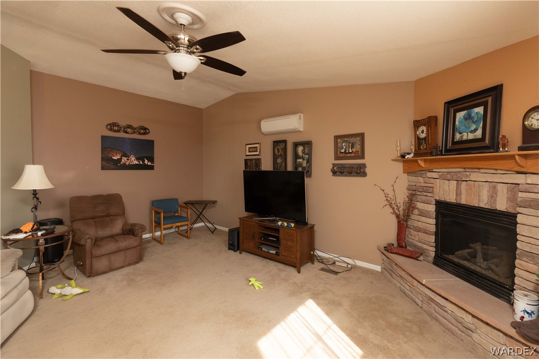 1464 South Dragoon Road Golden Valley, AZ 86413 - Photo 6 of 47 a living room with furniture and a fireplace