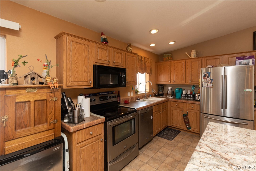 1464 South Dragoon Road Golden Valley, AZ 86413 - Photo 7 of 47 a kitchen with a sink stove and refrigerator