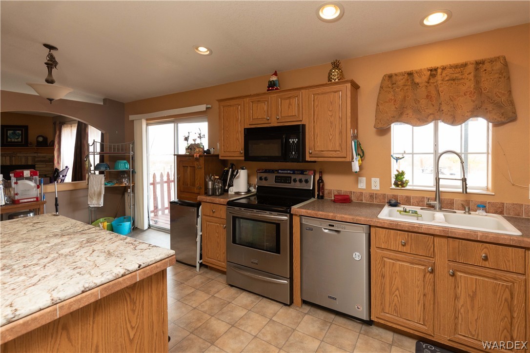 1464 South Dragoon Road Golden Valley, AZ 86413 - Photo 8 of 47 a kitchen with a sink stove and refrigerator