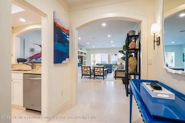 a room with furniture and view of kitchen