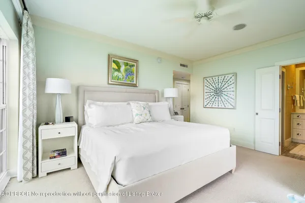 a bedroom with a bed and a lamp