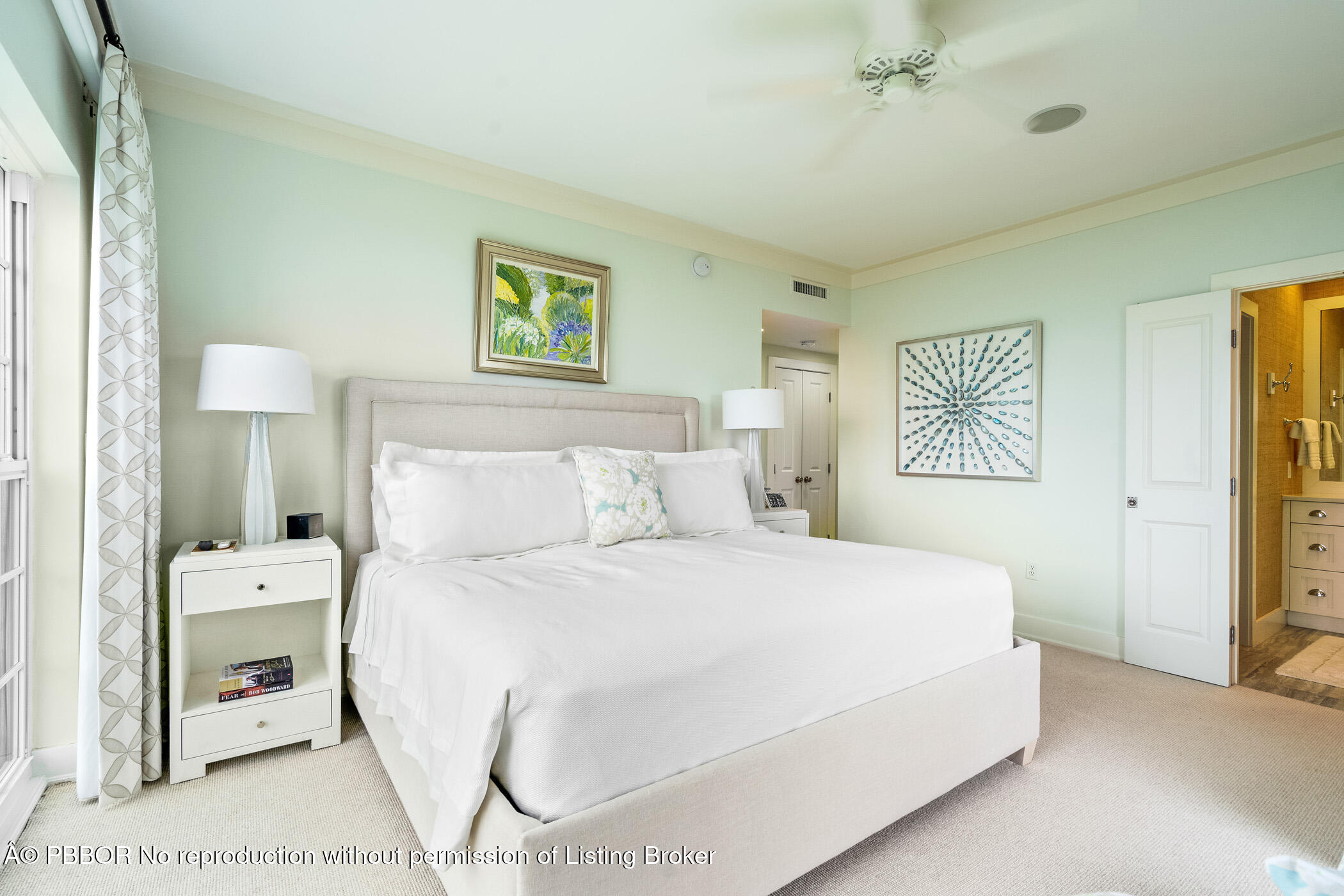 750 Beach Road, Unit 102 Vero Beach, FL 32963 - Photo 23 of 28 a bedroom with a bed and a lamp