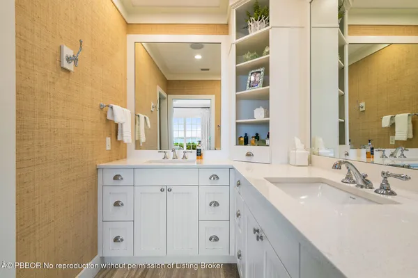 a bathroom with a sink double vanity and a mirror