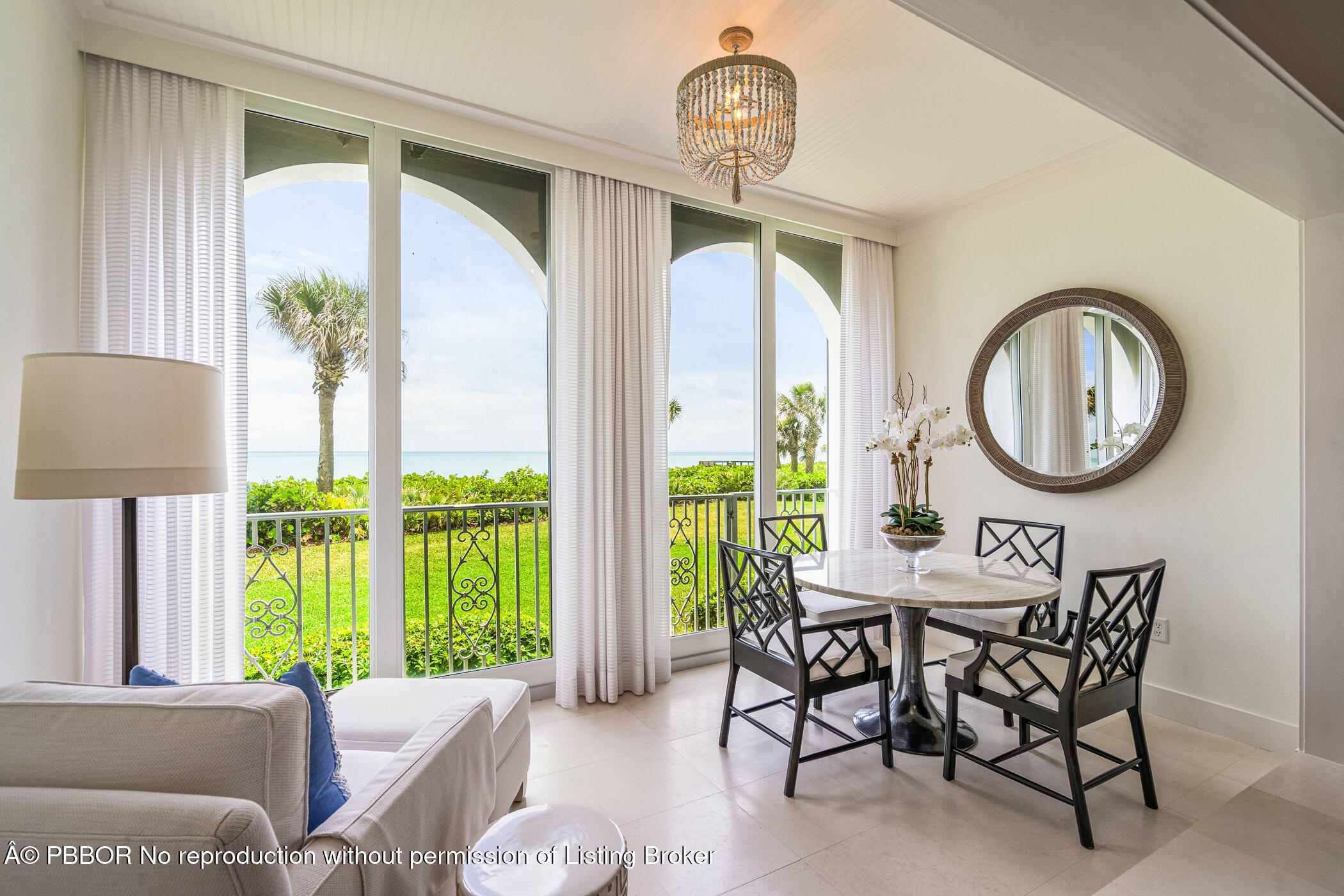 750 Beach Road, Unit 102 Vero Beach, FL 32963 - Photo 8 of 28 a living room with furniture a table and a large window