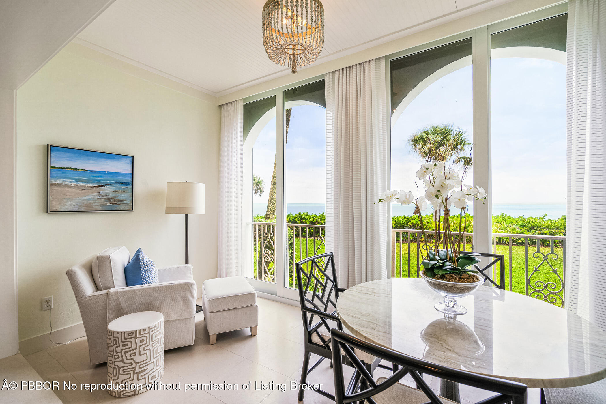 750 Beach Road, Unit 102 Vero Beach, FL 32963 - Photo 9 of 28 a dining room with furniture a large window and a chandelier