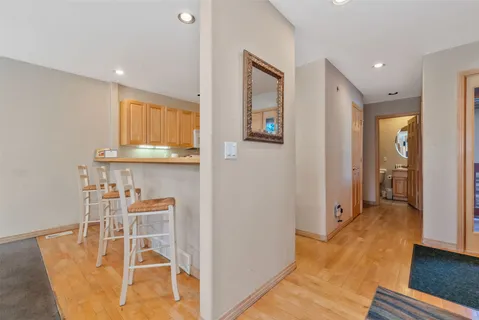 a view of a kitchen with furniture and wooden floor