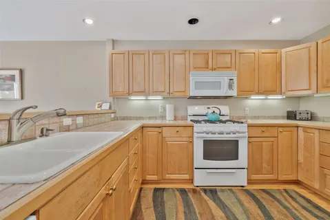 a kitchen with stainless steel appliances granite countertop a sink and cabinets