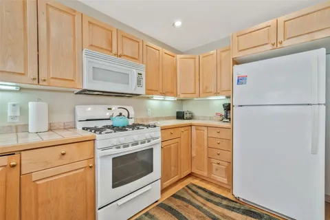 a kitchen with stainless steel appliances granite countertop a refrigerator sink and cabinets