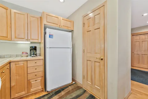 a white refrigerator freezer sitting in a kitchen