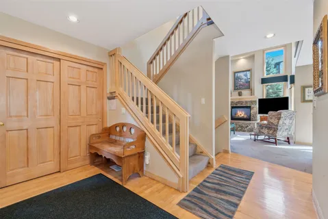 a view of a livingroom with wooden floor and furniture