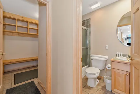 a white toilet sitting next to a bathroom sink