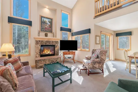 a living room with furniture fireplace and a flat screen tv