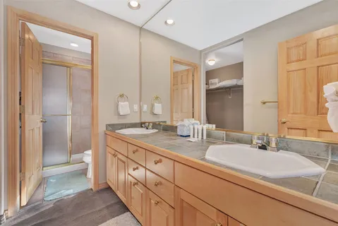 a bathroom with a double vanity sink mirror and double