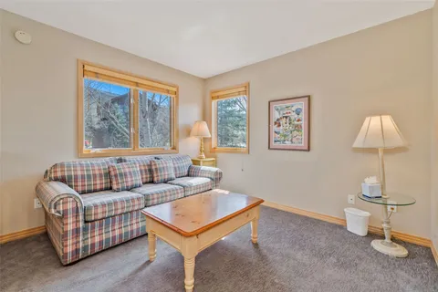 a living room with furniture a lamp and a window