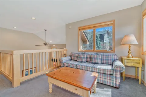 a living room with furniture a table and a window