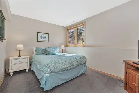 a bedroom with a bed and a night stand