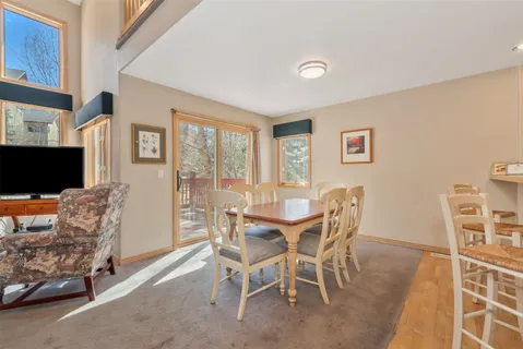 a dining room with furniture and a flat screen tv
