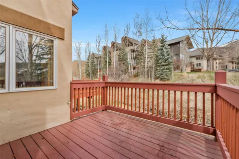 a view of a balcony with wooden floor and fence